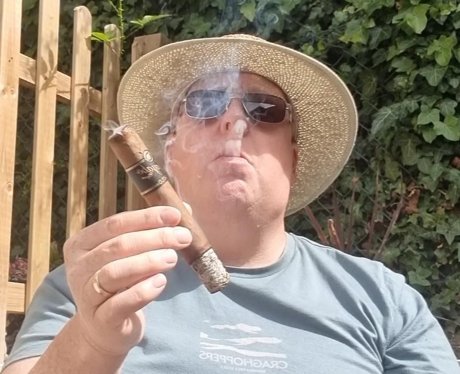 Buster Cigars founder enjoying a cigar outdoors